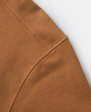 Vintage long-sleeve henley shirt cuff and side seam in dark orange, ribbed knit