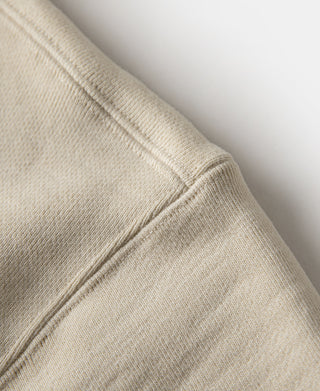 Cream ribbed cuff and side seam detail on a ski sweatshirt sleeve