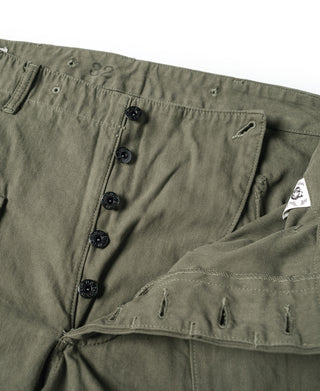 Olive utility pants waist detail with button fly and front pocket flaps
