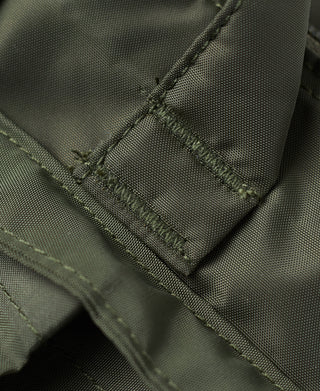 Olive nylon bag corner detail with stitched seams and pocket panel