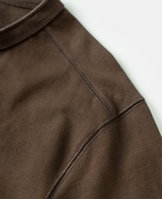 Coffee-brown henley shirt sleeve seam and ribbed cuff detail