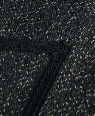 Dark salt-and-pepper wool fabric closeup with textured weave