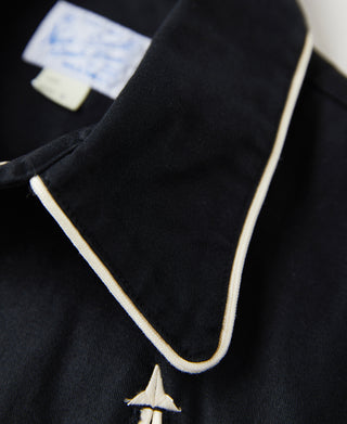 Black western shirt detail of pointed white collar trim and arrow embroidery