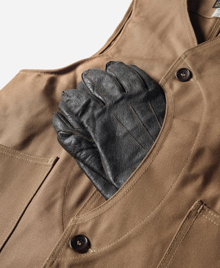 Khaki canvas hunting vest with black button and top pocket opening