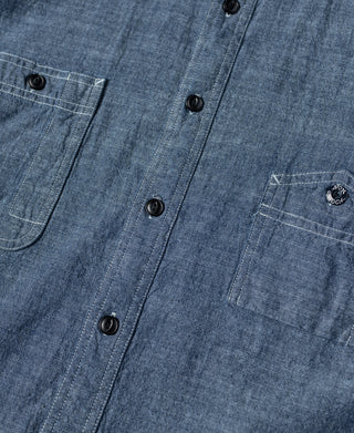 Blue chambray work shirt front placket with dark buttons and stitched seams