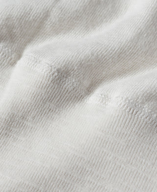 White knit henley T-shirt fabric texture close-up at chest