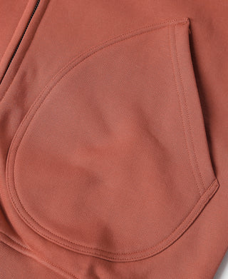 Brick red terry cloth hoodie kangaroo pocket detail, curved pocket opening