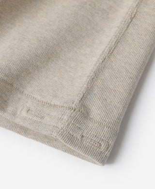 Close-up of light heather beige hem with ribbed knit finish