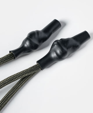 Black drawcord ends with woven cords for closing the olive chalk bag