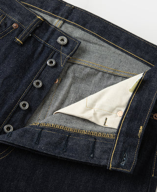 Indigo denim jeans interior waistband with striped lining and metal buttons
