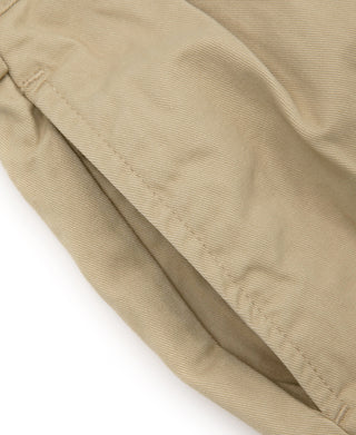 Khaki chino fabric close-up with pleat detail on the trouser front