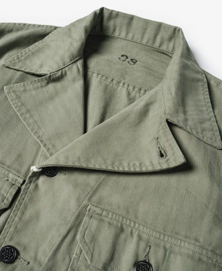 Olive fatigue jacket with buttoned chest pocket and fold-over collar