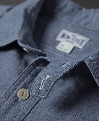 Blue chambray shirt with inner neck label and beige button