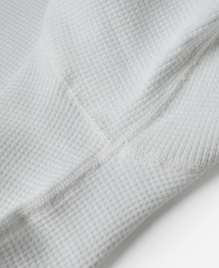 White ribbed waffle-knit cotton sleeve cuff seam close-up
