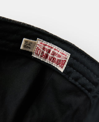 Black and gray newsboy cap with interior fabric lining and brand label.