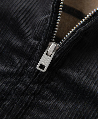 Silver-tone metal zipper on black corduroy jacket