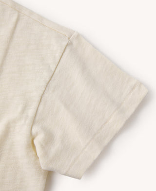 Light apricot crew-neck slub cotton T-shirt sleeve and side seam close-up