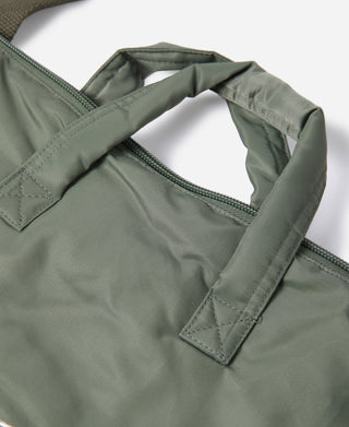 Olive tote bag detail showing reinforced handle strap and top seam stitching