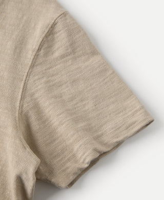 Light tan T-shirt sleeve cuff and side seam close-up