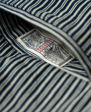 Cream striped work pants, interior size label on blue-and-cream stripe fabric