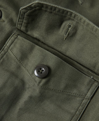 Olive fatigue utility shirt pocket flap with button and stitched pocket edge