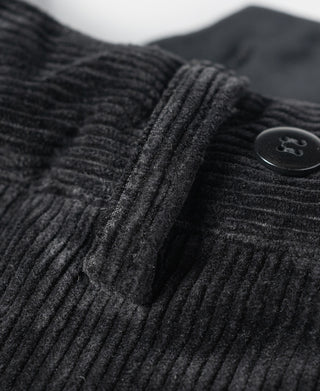 Black corduroy waistband with button and smooth inner pleat fold.
