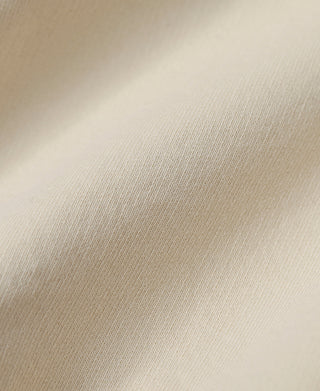 Apricot sweatshirt fabric close-up with smooth knit texture