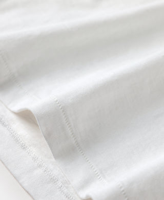White T-shirt fabric close-up with textured slub weave