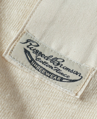 Beige henley inner label close-up with embroidered logo