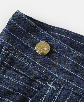 Indigo pinstripe waistband close-up with gold-toned snap button and seam details