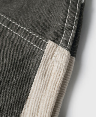Wide striped prisoner pants fabric close-up with white and black stripe and visible stitching.