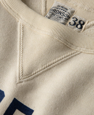 Cream sweatshirt collar and “38” neck label with blue printed graphic edge