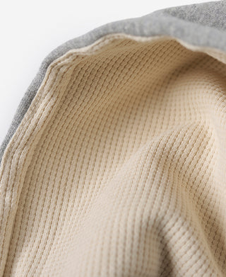Cream knit-lined hood with ribbed texture inside gray hood opening