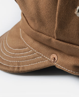 Ginger duck canvas cap close-up: curved stitched brim and round snap closure