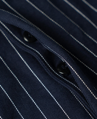 Navy pinstripe pocket detail with two dark buttons