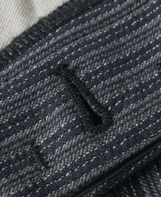 Striped pants fabric close-up with seam and pocket stitching