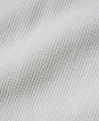 Close-up of white heavyweight waffle-knit cotton fabric texture