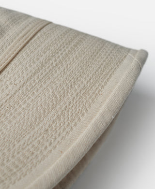 Off-white hat brim corner with seam line and textured fabric