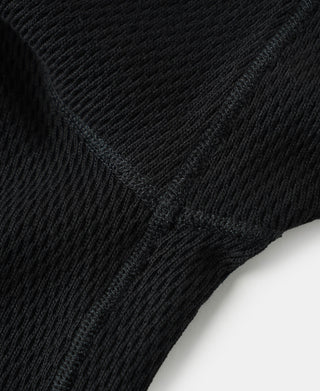 Black thermal shirt sleeve seam with waffle knit texture and ribbed cuff