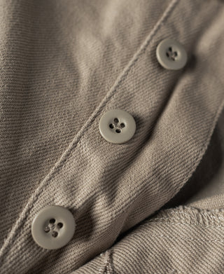 Khaki chino pants button placket with round gray buttons