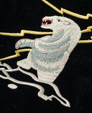 Embroidered light blue and white animal graphic on black jacket
