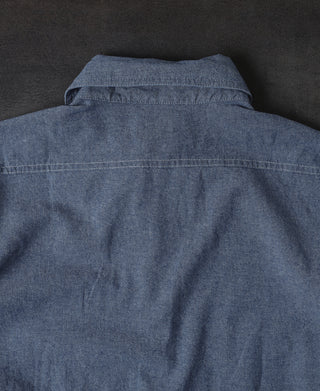 Blue chambray shirt back with yoke seam and stitched collar