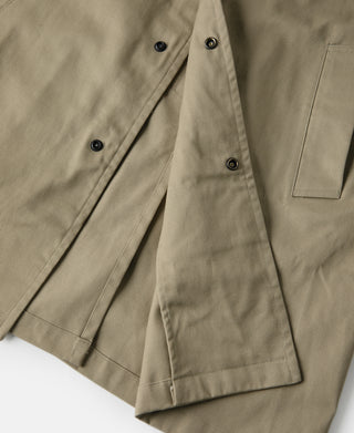 Khaki trench coat interior hem and buttoned placket close-up