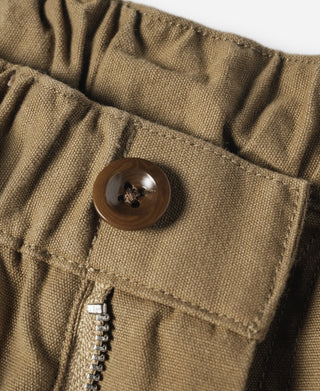 Khaki cotton canvas waistband detail with button closure and gathered elastic