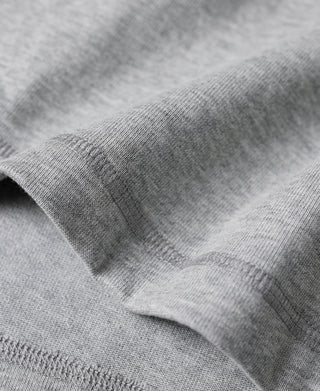 Gray fabric texture and curved cuff seam on long-sleeve henley shirt