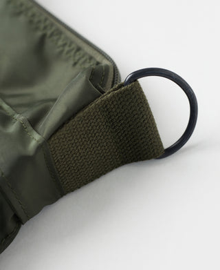 Olive nylon bag side with webbing handle loop and textured fabric trim