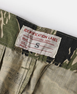 Tiger stripe camo fatigue pants interior size label, stitching, and waistband seam.