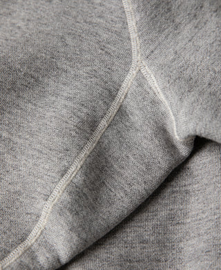Gray raglan sweater with contrast seam along sleeve and side.