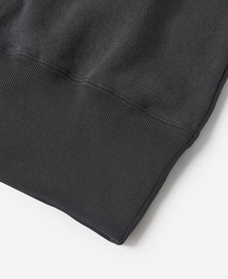 Black sweatshirt hem with ribbed trim, close-up.