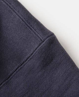 Navy sleeve with diagonal seam stitching and ribbed cuff